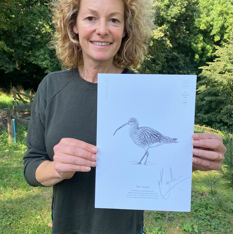 Kate with signed curlew print supporting Wildfowl and Wetlands Trust